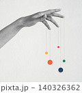 Hand controlling colorful circles with puppet strings 140326362