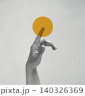 Hand touching yellow circle on gray background 140326369