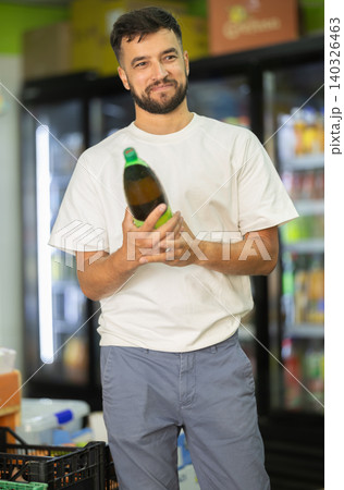 Buyer view assortment, man choose non-alcoholic drink 140326463