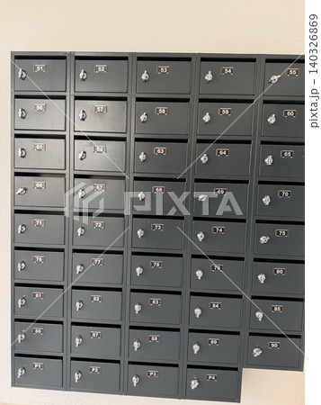Black metal mailboxes on a wall provide an organized structure, ideal for postal-inspired background Black metal mailboxes on a wall provide an organized structure, ideal for postal-inspired background 140326869