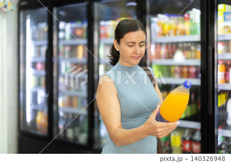 Buyer view assortment, woman choose non-alcoholic drink Buyer view assortment, woman choose non-alcoholic drink 140326948