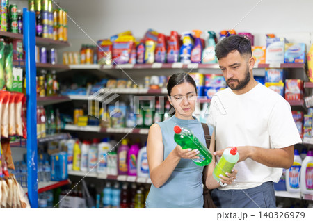examines product dishwashing detergent in store examines product dishwashing detergent in store 140326979