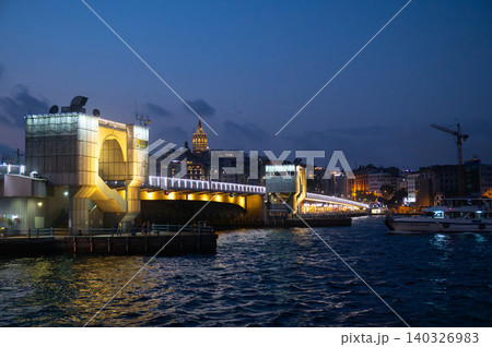 Istanbul, Turkiye at Dusk: Illuminated Bridge and Cityscape Refl Istanbul, Turkiye at Dusk: Illuminated Bridge and Cityscape Refl 140326983