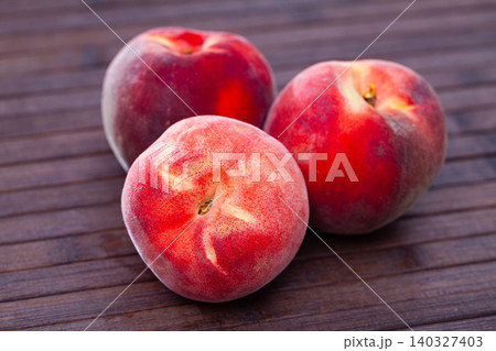 Whole and half fresh red peaches on wooden table. Whole and half fresh red peaches on wooden table. 140327403
