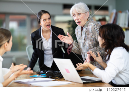 Angry group of female colleagues arguing during office meeting Angry group of female colleagues arguing during office meeting 140327445
