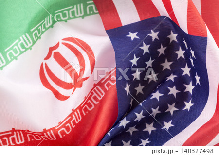 Flags of the United States and Iranian together. Concept of geopolitical tension between the two countries. International relations. political negotiations. Flags of the United States and Iranian together. Concept of geopolitical tension between the two countries. International relations. political negotiations. 140327498