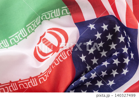Flags of the United States and Iranian together. Concept of geopolitical tension between the two countries. International relations. political negotiations. Flags of the United States and Iranian together. Concept of geopolitical tension between the two countries. International relations. political negotiations. 140327499