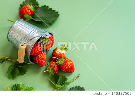 Rustic metal bucket filled with fresh strawberries Rustic metal bucket filled with fresh strawberries 140327505