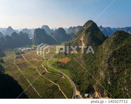 Aerial View of Karst Mountains and Lush Green Fields in Guangxi, China Aerial View of Karst Mountains and Lush Green Fields in Guangxi, China 140327712