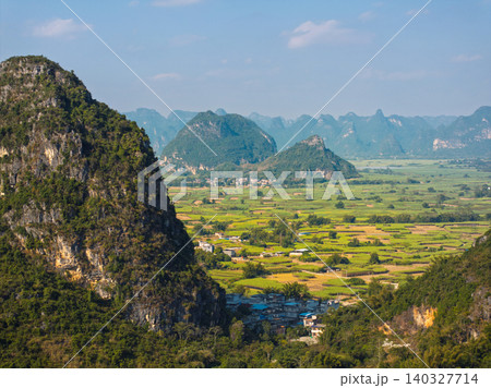 Scenic Landscape of Guangxi, China with Mountains and Fields Under Clear Sky Scenic Landscape of Guangxi, China with Mountains and Fields Under Clear Sky 140327714