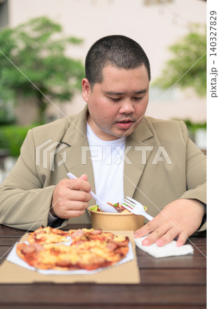 Plus size Isan Thai man eating salad at outdoor restaurant vertical Plus size Isan Thai man eating salad at outdoor restaurant vertical 140327829