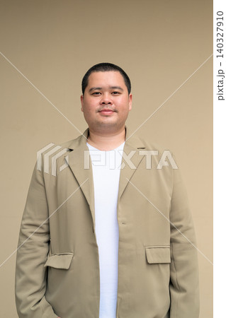 Confident plus size Isan Thai businessman portrait vertical 140327910