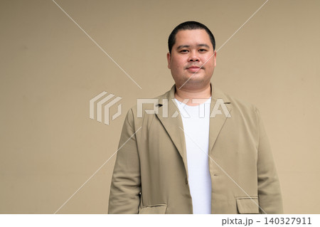 Confident plus size Isan Thai businessman with clean studio background 140327911