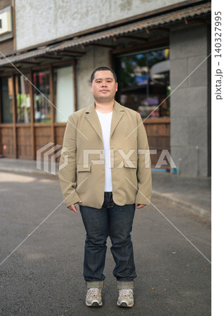Full length portrait of a plus size Isan Thai businessman on street Full length portrait of a plus size Isan Thai businessman on street 140327995