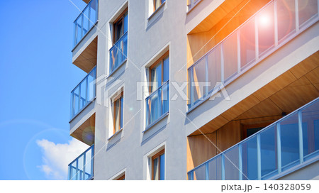 View of modern residential building with glass balconies and bright facade. Contemporary apartment building in european city. Concept of urban living and modern architecture.  140328059