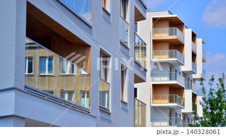 View of modern residential building with glass balconies and bright facade. Contemporary apartment building in european city. Concept of urban living and modern architecture.  140328061