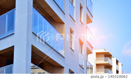 View of modern residential building with glass balconies and bright facade. Contemporary apartment building in european city. Concept of urban living and modern architecture.  140328062