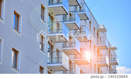 View of modern residential building with glass balconies and bright facade. Contemporary apartment building in european city. Concept of urban living and modern architecture. View of modern residential building with glass balconies and bright facade. Contemporary apartment building in european city. Concept of urban living and modern architecture. 140328064