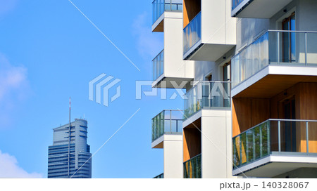 View of modern residential building with glass balconies and bright facade. Contemporary apartment building in european city. Concept of urban living and modern architecture.  140328067