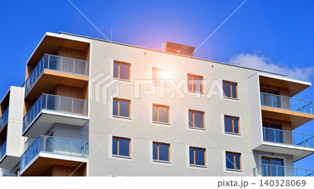 View of modern residential building with glass balconies and bright facade. Contemporary apartment building in european city. Concept of urban living and modern architecture.  140328069