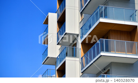 View of modern residential building with glass balconies and bright facade. Contemporary apartment building in european city. Concept of urban living and modern architecture.  140328070