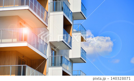 View of modern residential building with glass balconies and bright facade. Contemporary apartment building in european city. Concept of urban living and modern architecture. View of modern residential building with glass balconies and bright facade. Contemporary apartment building in european city. Concept of urban living and modern architecture. 140328071
