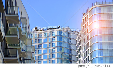 View of modern residential building with glass balconies and bright facade. Contemporary apartment building in european city. Concept of urban living and modern architecture.  140328143
