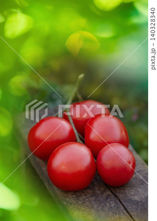 Fresh ripe organic garden round tomatoes on wooden table. Tomatoes on wooden background. Tomatoes red on wood Fresh ripe organic garden round tomatoes on wooden table. Tomatoes on wooden background. Tomatoes red on wood 140328340