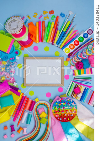 Multicolored craft supplies with copyspace. Craft supplies for creative handmade. Empty picture frame mock up. Multicolored craft supplies with copyspace. Craft supplies for creative handmade. Empty picture frame mock up. 140328411