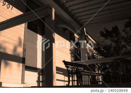 House porch bench bathing in warm afternoon light 140328649