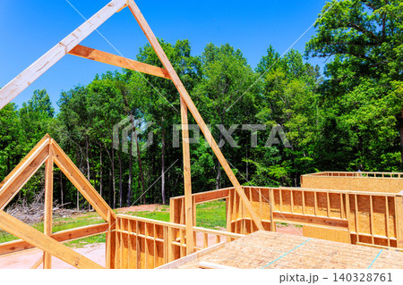 Workers are building beams structure framing stage unfinished house Workers are building beams structure framing stage unfinished house 140328761