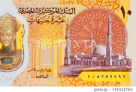 Egyptian Ten pounds EGP polymer banknote featuring Pharaoh Ramses II beside pyramids design. Egyptian Ten pounds EGP polymer banknote featuring Pharaoh Ramses II beside pyramids design. 140328763