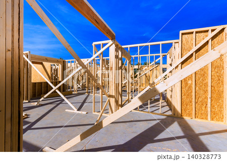 Workers build structure with wooden frames beams bracing in construction area Workers build structure with wooden frames beams bracing in construction area 140328773