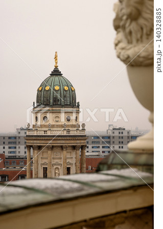 Rooftop view of the New German Cathedral golden adorned Dome in Berlin from the French Church terrace, showing contrast between historical and modern architecture, Foggy cloudy day. Copy space Rooftop view of the New German Cathedral golden adorned Dome in Berlin from the French Church terrace, showing contrast between historical and modern architecture, Foggy cloudy day. Copy space 140328885