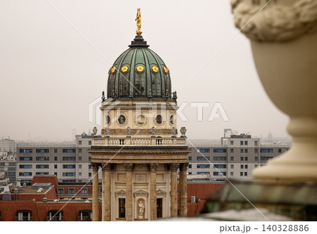 Rooftop view of the New German Cathedral golden adorned Dome in Berlin from the French Church terrace, showing contrast between historical and modern  architecture, Foggy cloudy day. Copy space 140328886