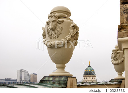Rooftop view of the New German Cathedral golden adorned Dome in Berlin from the French Church terrace, showing contrast between historical and modern architecture, Foggy cloudy day. Copy space Rooftop view of the New German Cathedral golden adorned Dome in Berlin from the French Church terrace, showing contrast between historical and modern architecture, Foggy cloudy day. Copy space 140328888
