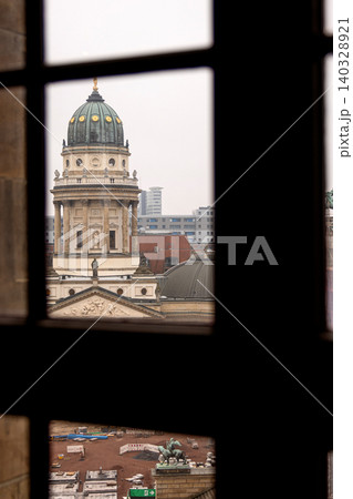 Scenic city view from French Church tower overlooking Gendarmenmarkt square with Concert Hall and German cathedral under reconstruction. Historic architecture of Berlin. Selective focus Scenic city view from French Church tower overlooking Gendarmenmarkt square with Concert Hall and German cathedral under reconstruction. Historic architecture of Berlin. Selective focus 140328921