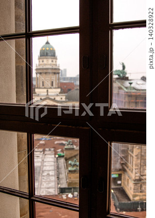 Scenic city view from French Church tower overlooking Gendarmenmarkt square with Concert Hall and German cathedral under reconstruction. Historic architecture of Berlin. Selective focus Scenic city view from French Church tower overlooking Gendarmenmarkt square with Concert Hall and German cathedral under reconstruction. Historic architecture of Berlin. Selective focus 140328922