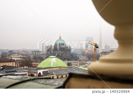 Berlin skyline with historic and modern sights. Panoramic birds eye view of foggy Berlin from the rooftop of French Church. Historic and modern landmarks on a misty day. Copy space Berlin skyline with historic and modern sights. Panoramic birds eye view of foggy Berlin from the rooftop of French Church. Historic and modern landmarks on a misty day. Copy space 140328984