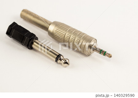 Mini-jack connector with adapter on a white background 140329590