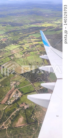 Landscape under the wing of an airplane during flight Landscape under the wing of an airplane during flight 140329703