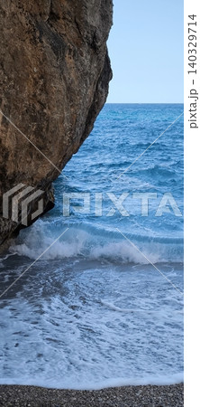 A rocky beach with crystal clear blue water hidden among the rocks A rocky beach with crystal clear blue water hidden among the rocks 140329714