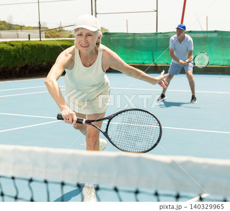 Senior woman plays tennis Senior woman plays tennis 140329965