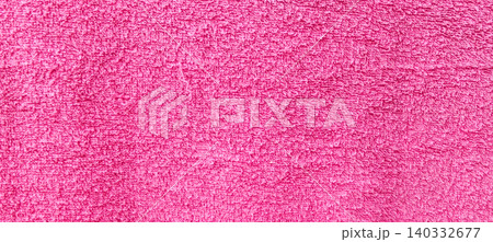 A close-up of the texture of the pink towel fabric, with soft fibers and clear surface details. A close-up of the texture of the pink towel fabric, with soft fibers and clear surface details. 140332677