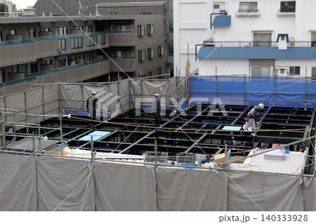 steel frame construction, Construction Workers Installing Steel Frame Structure at Urban Building Site steel frame construction, Construction Workers Installing Steel Frame Structure at Urban Building Site 140333928