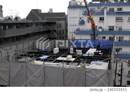 steel frame construction, Construction Workers Installing Steel Frame Structure at Urban Building Site steel frame construction, Construction Workers Installing Steel Frame Structure at Urban Building Site 140333933