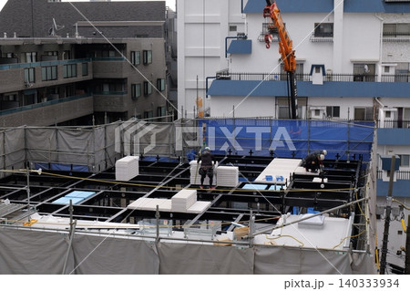 steel frame construction, Construction Workers Installing Steel Frame Structure at Urban Building Site 140333934