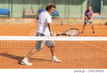 Two men playing lawn tennis outdoors 140334055