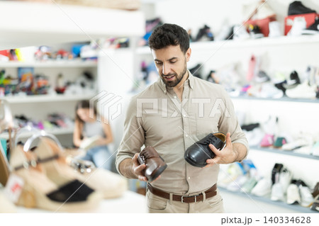 Adult man choosing classic men's dress shoes at shoe store Adult man choosing classic men's dress shoes at shoe store 140334628