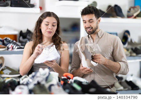 Young choosing sneakers together at shoe store Young choosing sneakers together at shoe store 140334790